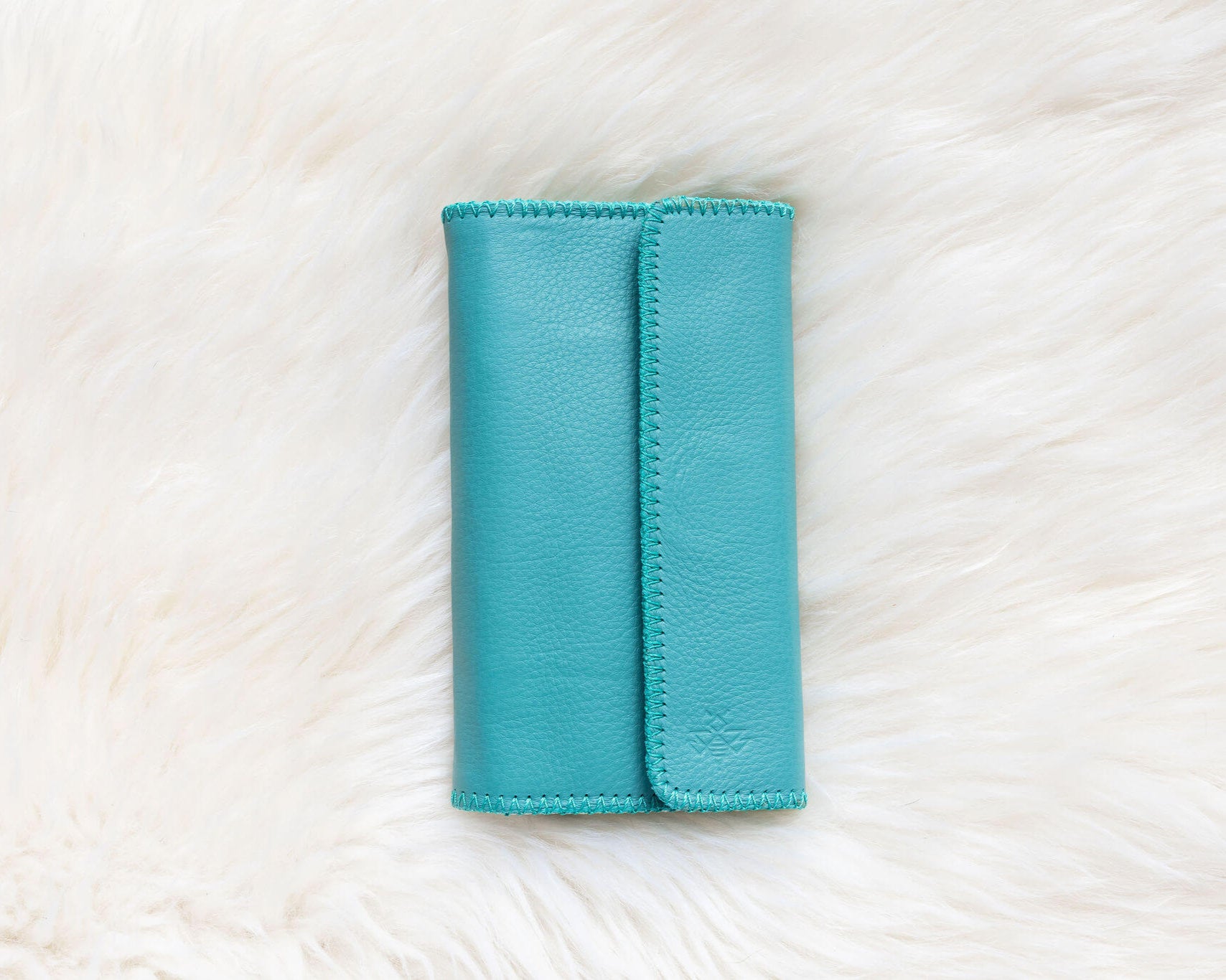 Turquoise leather wallet for traveling