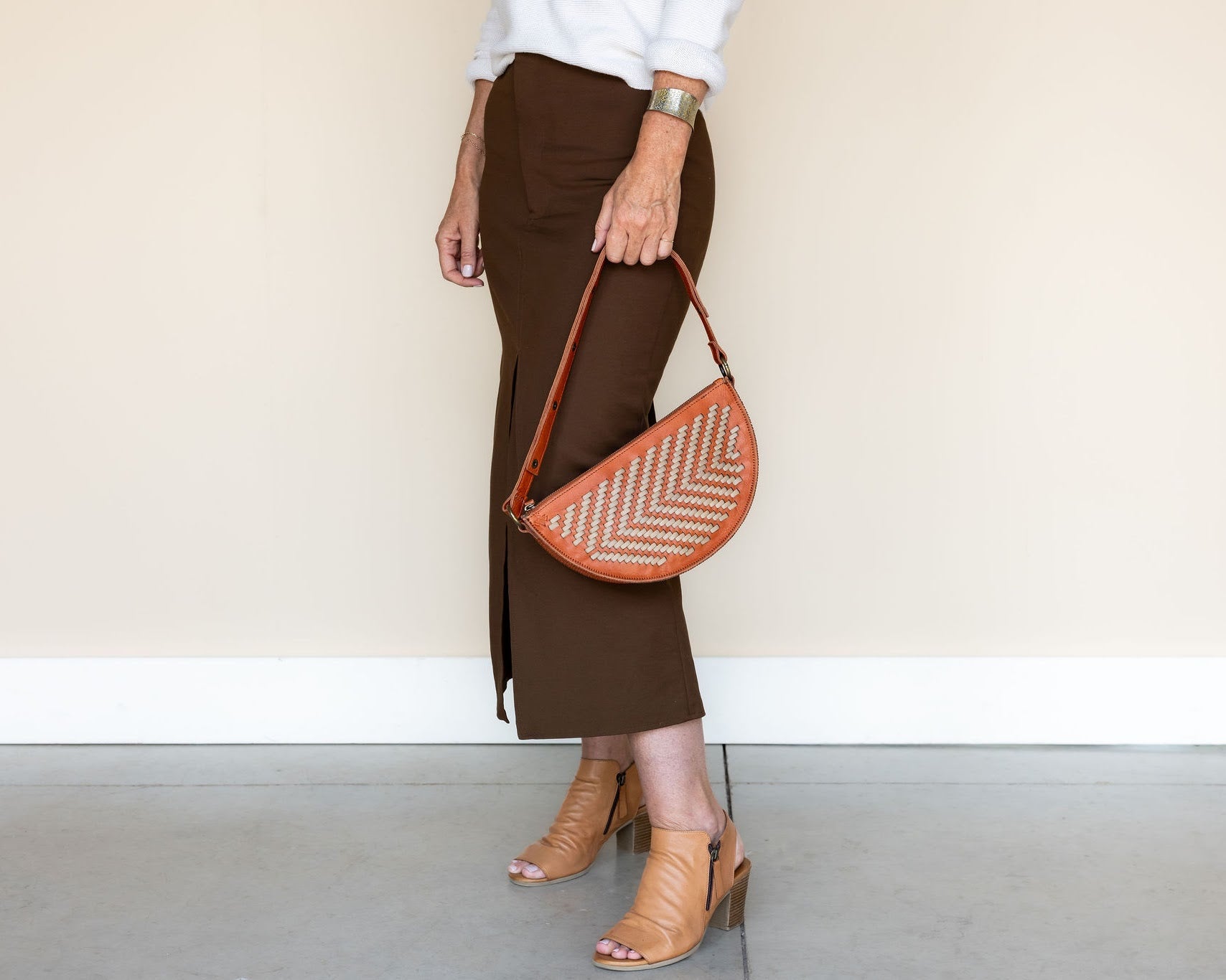 The Woven Terracotta & Seashell Biggie Bee styled with a midi skirt