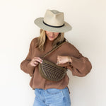 The Woven Sage & Espresso Bee worn as a shoulder bag