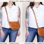 Person wearing a brown leather bag with two strap lengths displayed.