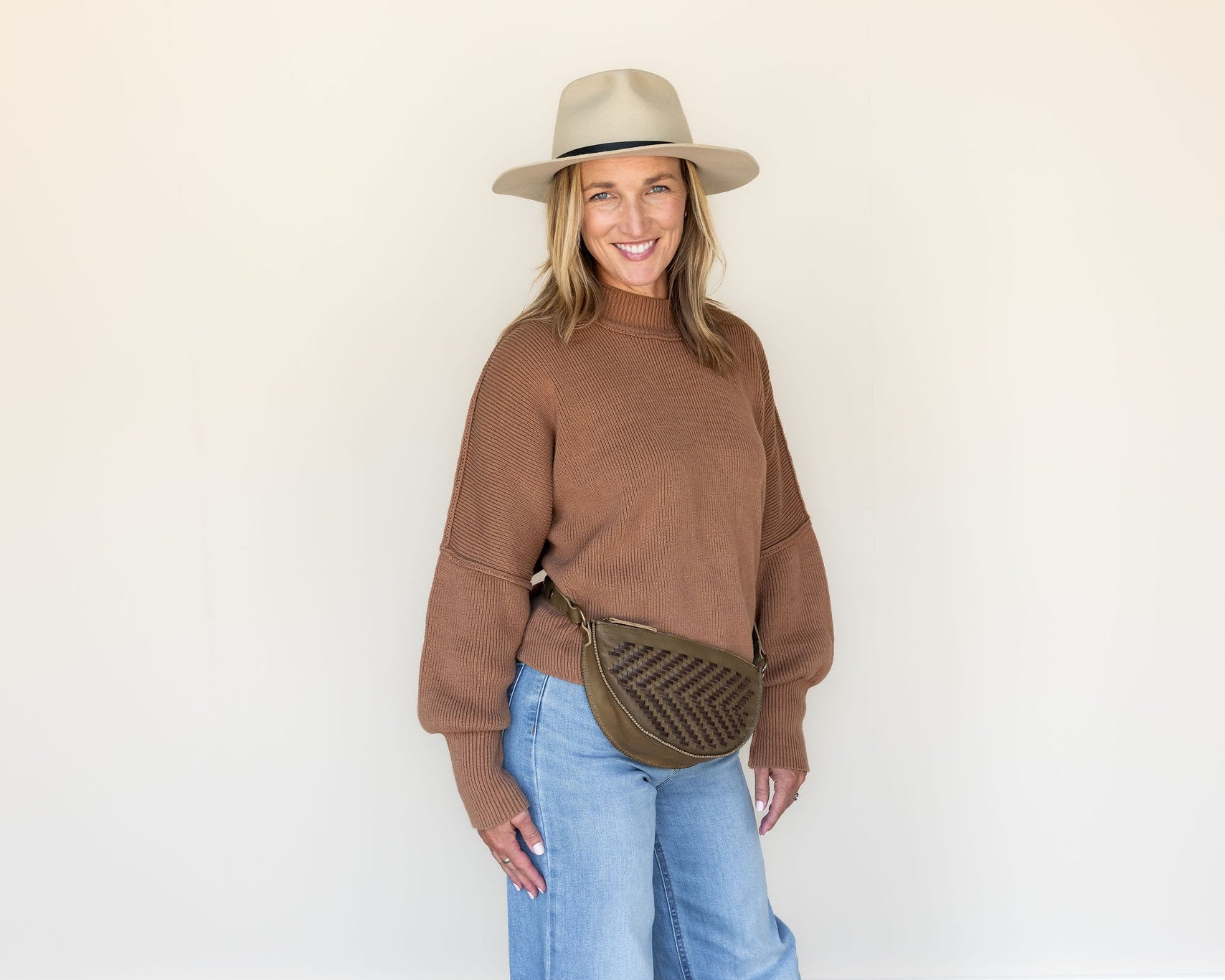 The Woven Sage & Espresso Bee worn as a waist pack