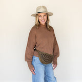 The Woven Sage & Espresso Bee worn as a waist pack