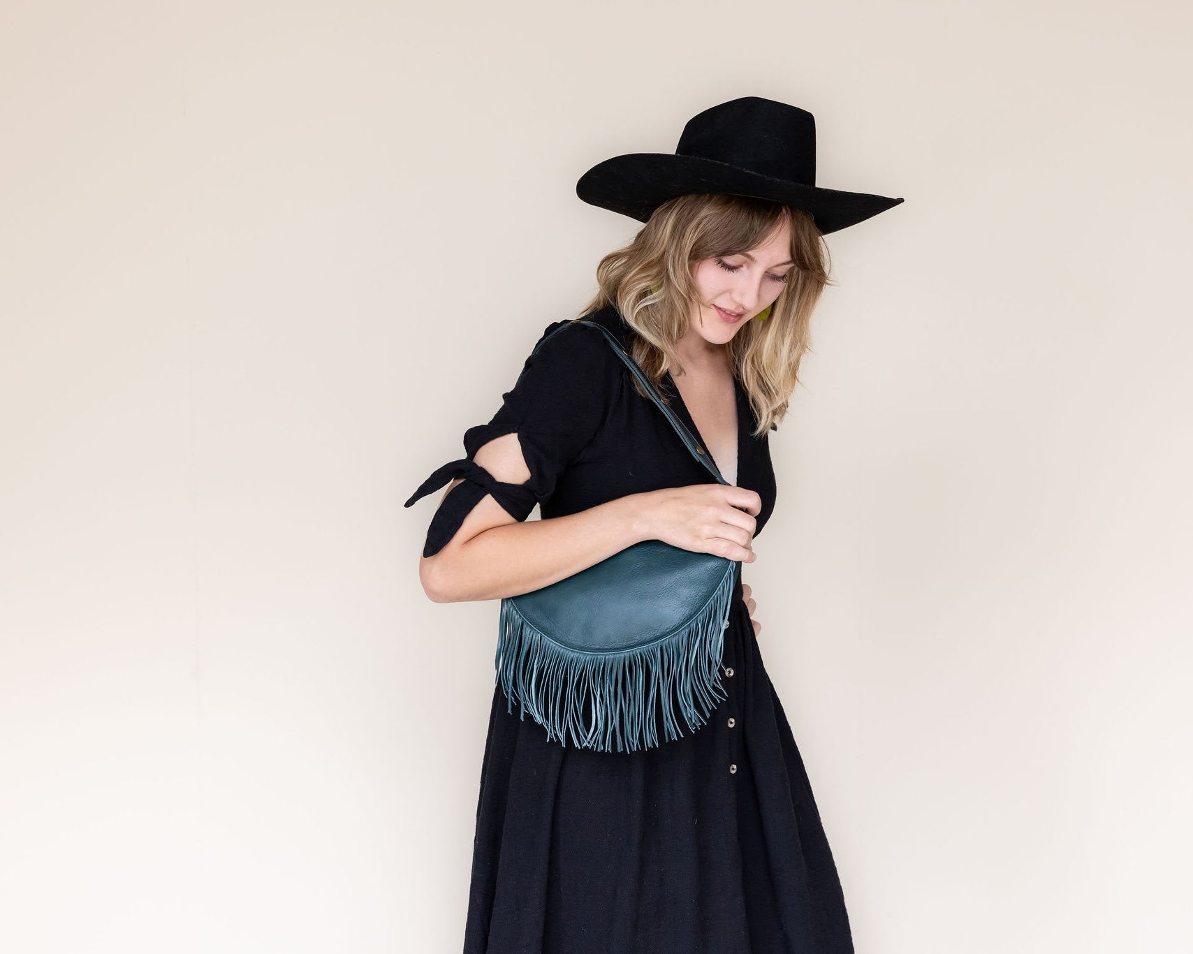 Medium teal leather fringe bag, side view
