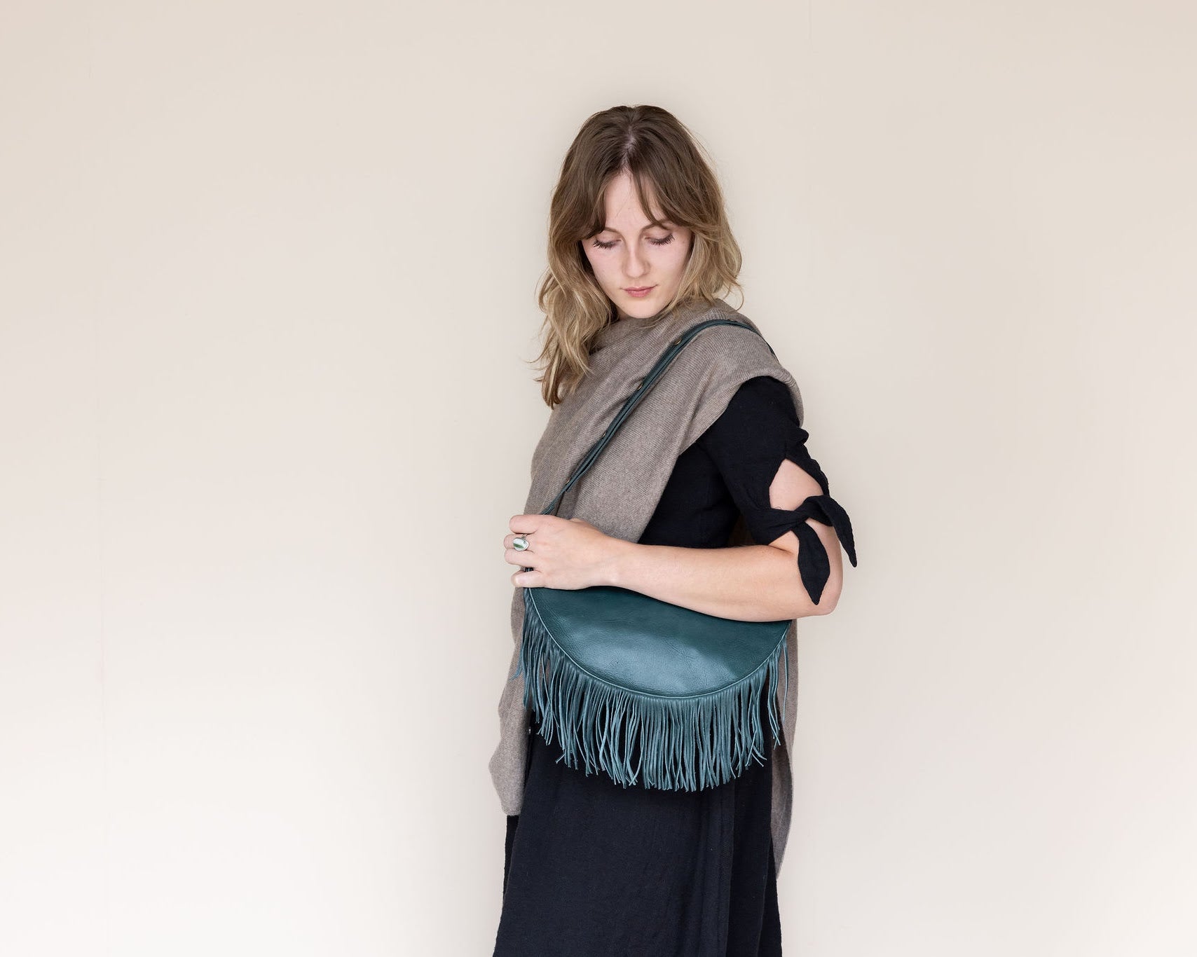 Large teal leather fringe bag, side view