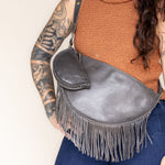 Mini charcoal leather pouch clipped to a charcoal leather fringe bag