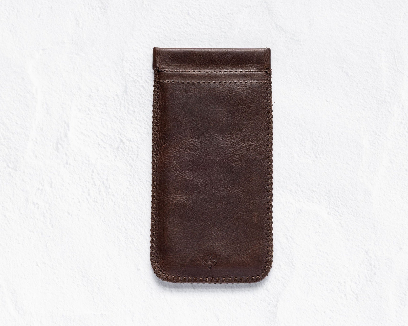 A dark brown leather phone pouch with a stitched border, shown flat against a textured white background.