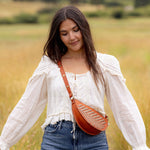 Woman wearing the Woven Terracotta & Seashell Bee as a crossbody bag