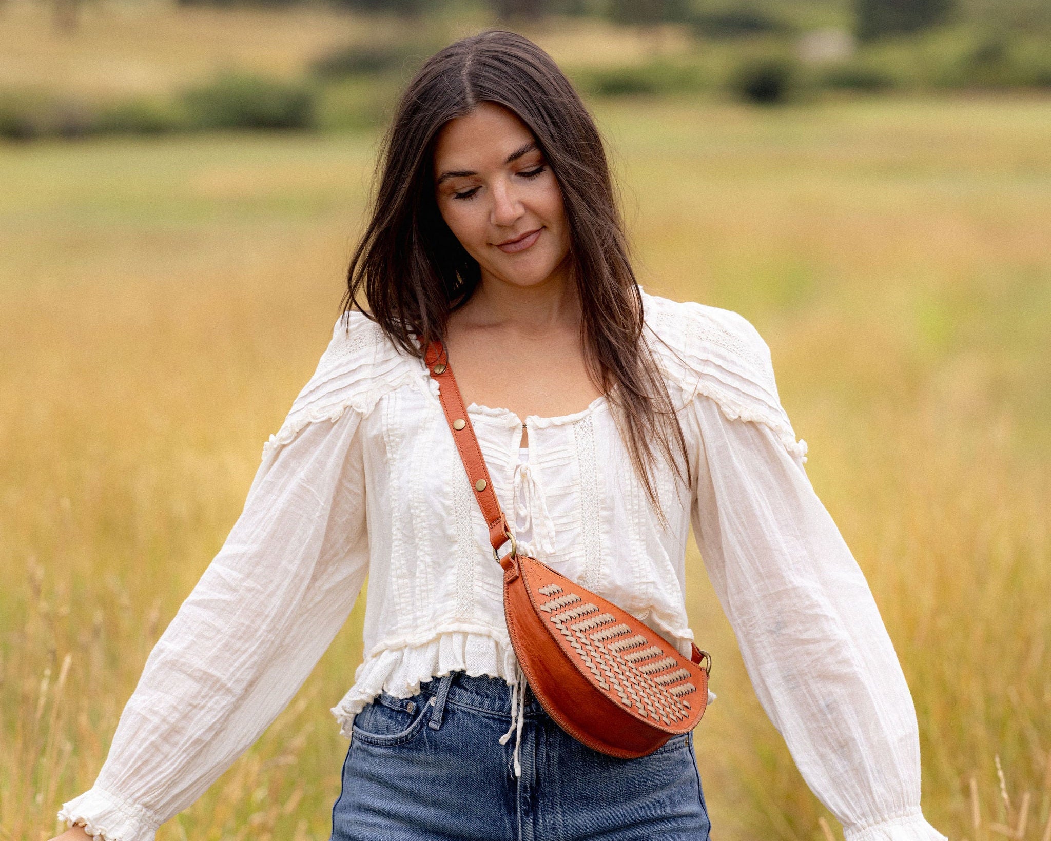 Woman wearing the Woven Terracotta & Seashell Bee as a crossbody bag