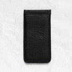 A black textured leather phone pouch or sleeve, shown vertically against a light gray, textured background.