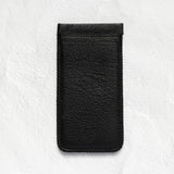 A black textured leather phone pouch or sleeve, shown vertically against a light gray, textured background.