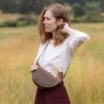 Woman wearing the Woven Sage & Espresso Bee as a crossbody bag