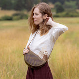 Woman wearing the Woven Sage & Espresso Bee as a crossbody bag
