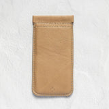 A tan leather phone pouch with a stitched top loop, displayed flat against a textured white background.