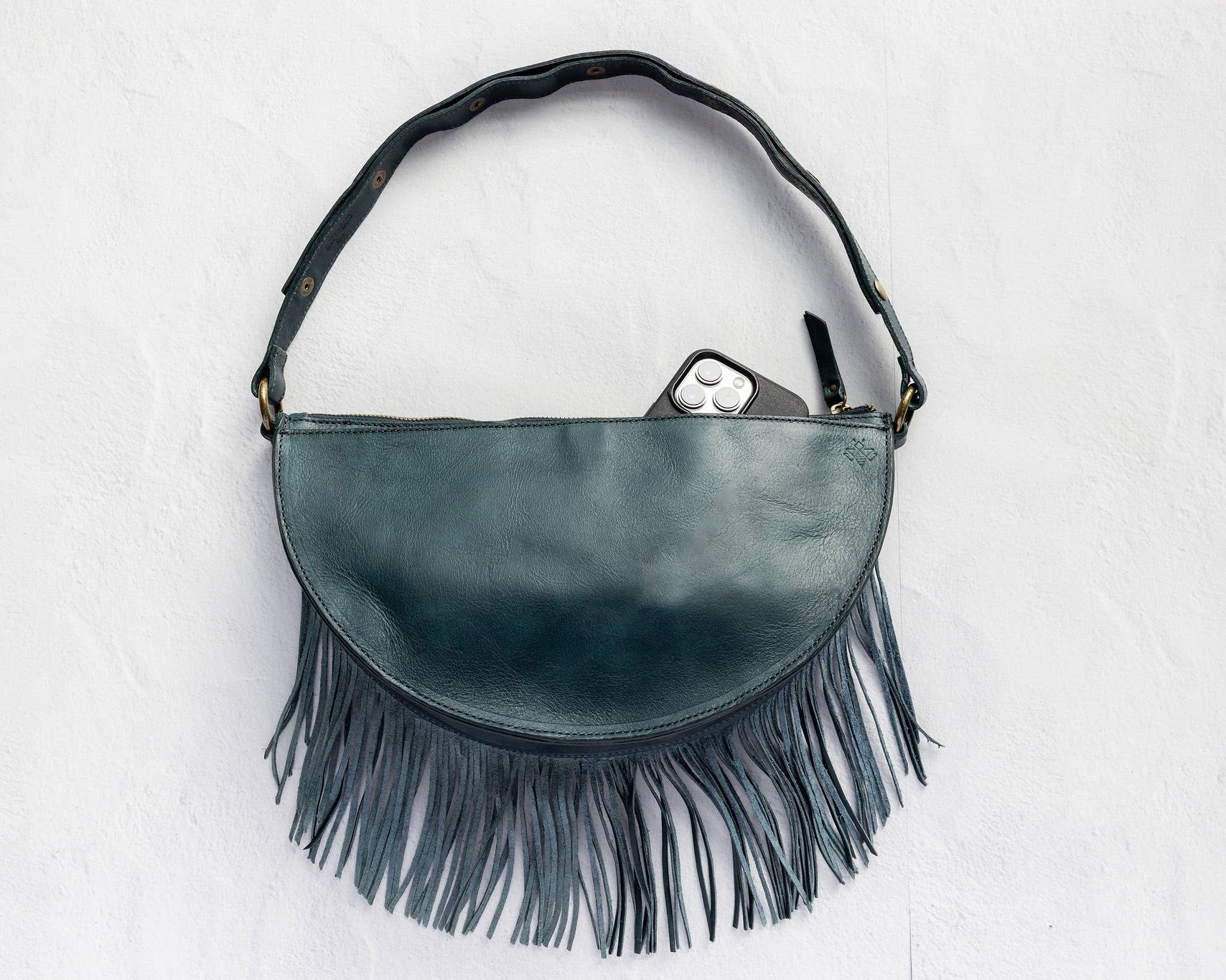 Medium teal leather fringe crossbody bag, back with phone pocket