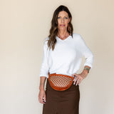 The Woven Terracotta & Seashell Bee worn as a waist pack