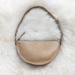 Beige handbag on a white fur surface