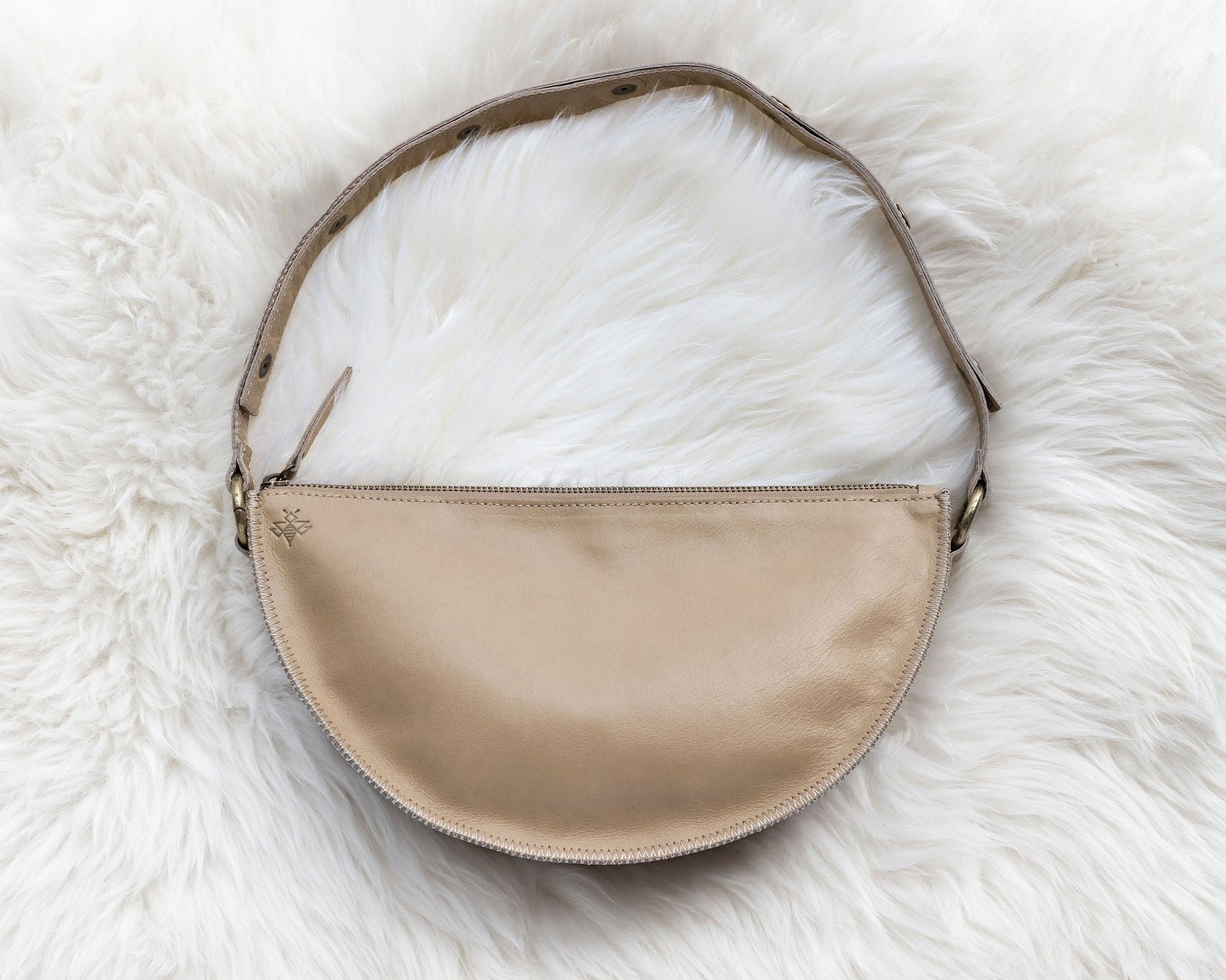 Beige handbag on a white fur surface