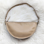 Beige handbag on a white fur surface