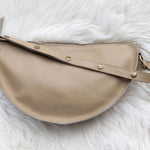 Beige handbag on a white fluffy surface