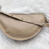 Beige handbag on a white fluffy surface
