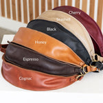 Leather bag with color swatches labeled on a white surface.