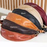 Leather bag with color swatches labeled on a white surface.