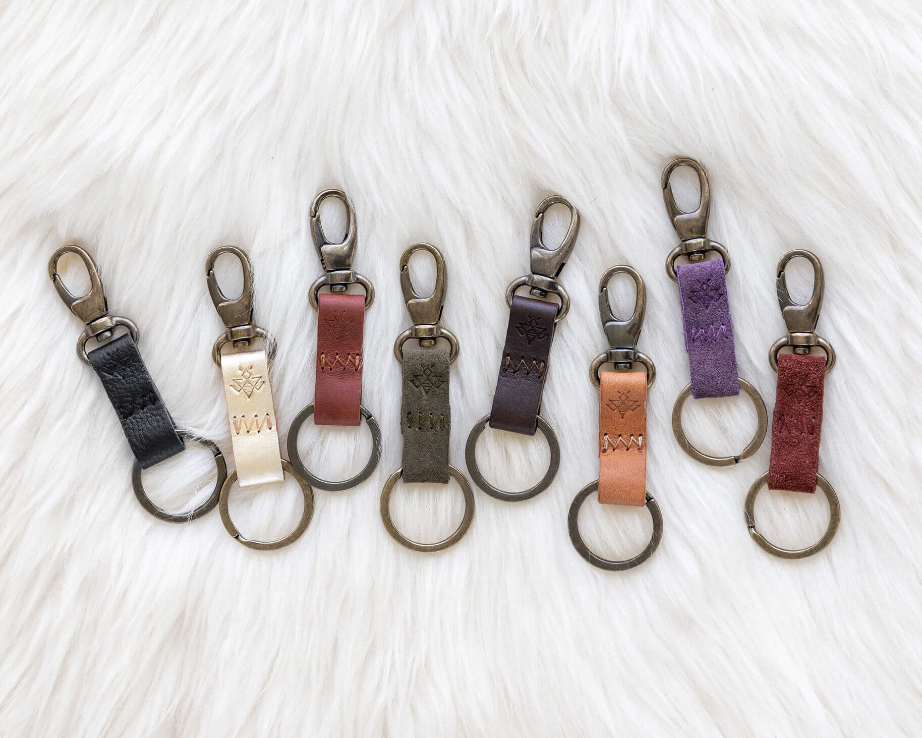 Set of keychains in various colors on a textured white background