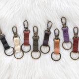 Set of keychains in various colors on a textured white background