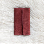 Red fabric pouch on a white fluffy surface