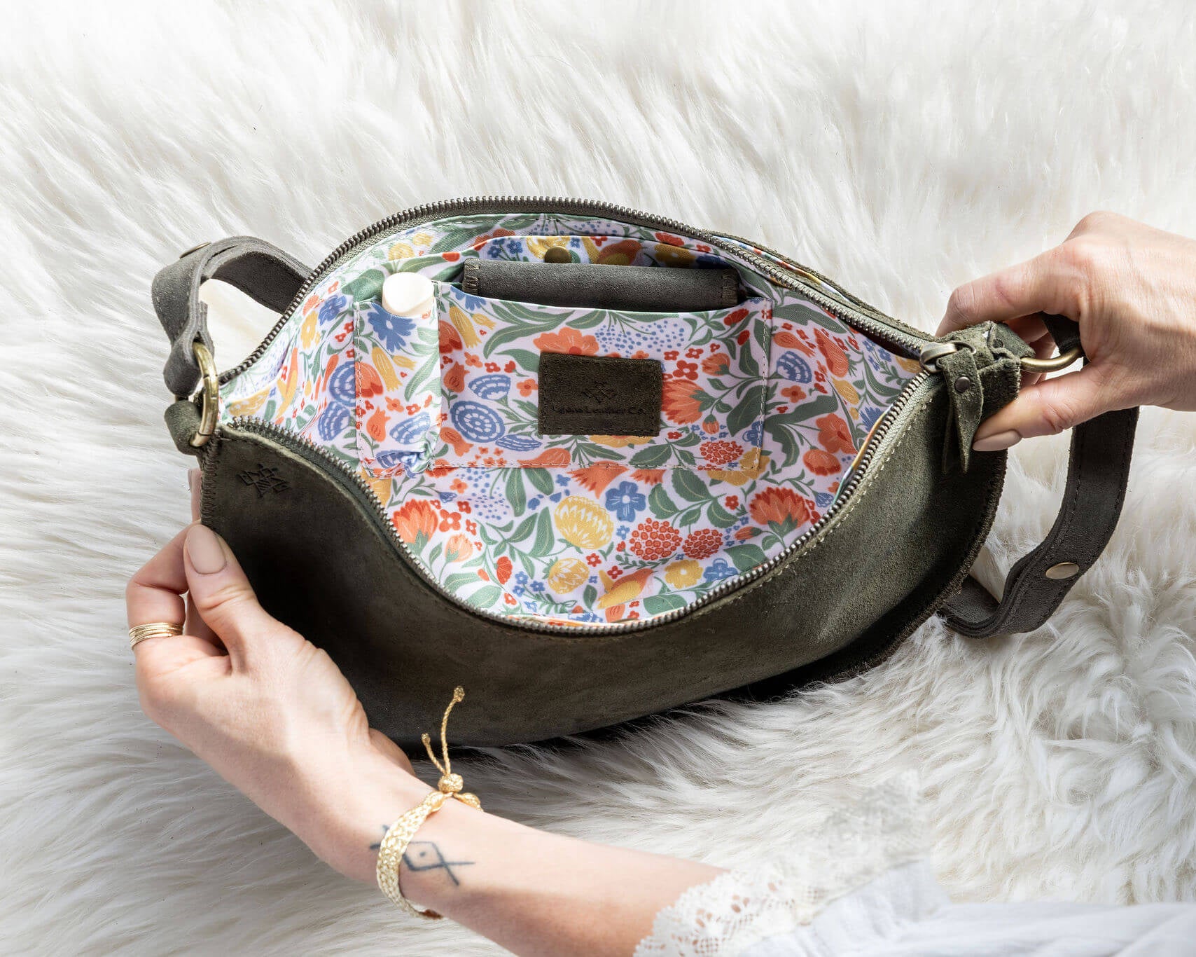 Handbag with floral interior on a white fur background