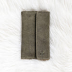 Gray fabric wallet on a white textured surface