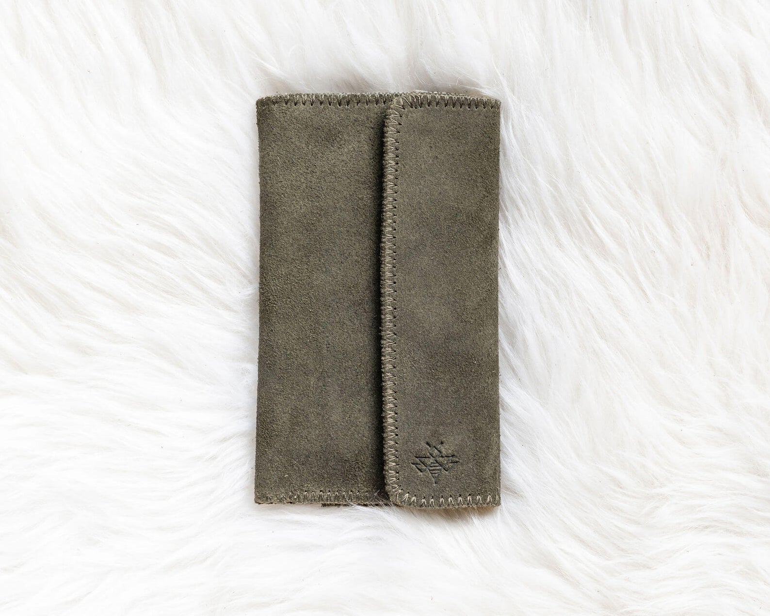 Gray fabric wallet on a white textured surface