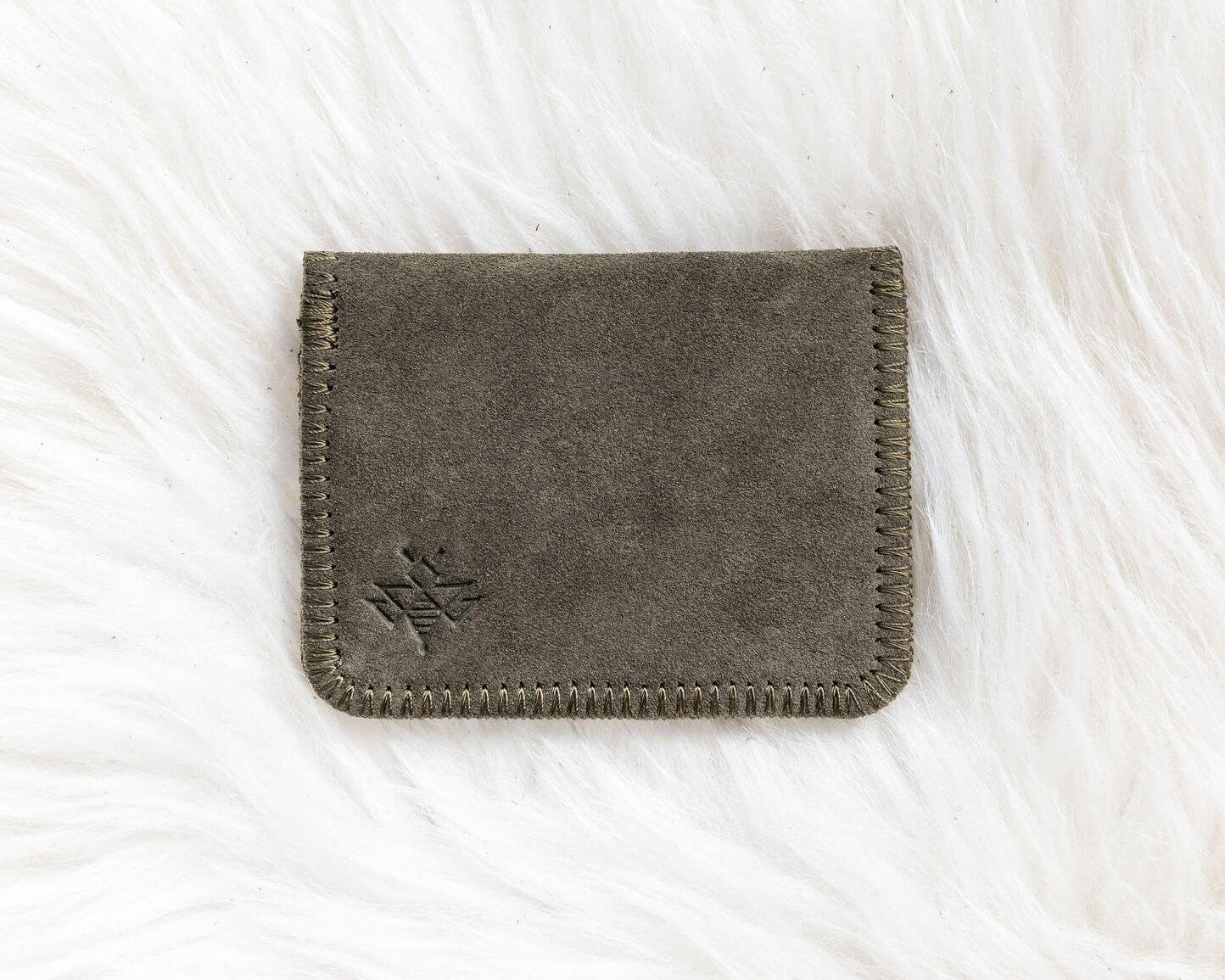 Gray fabric wallet on a white textured surface