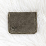 Gray fabric wallet on a white textured surface