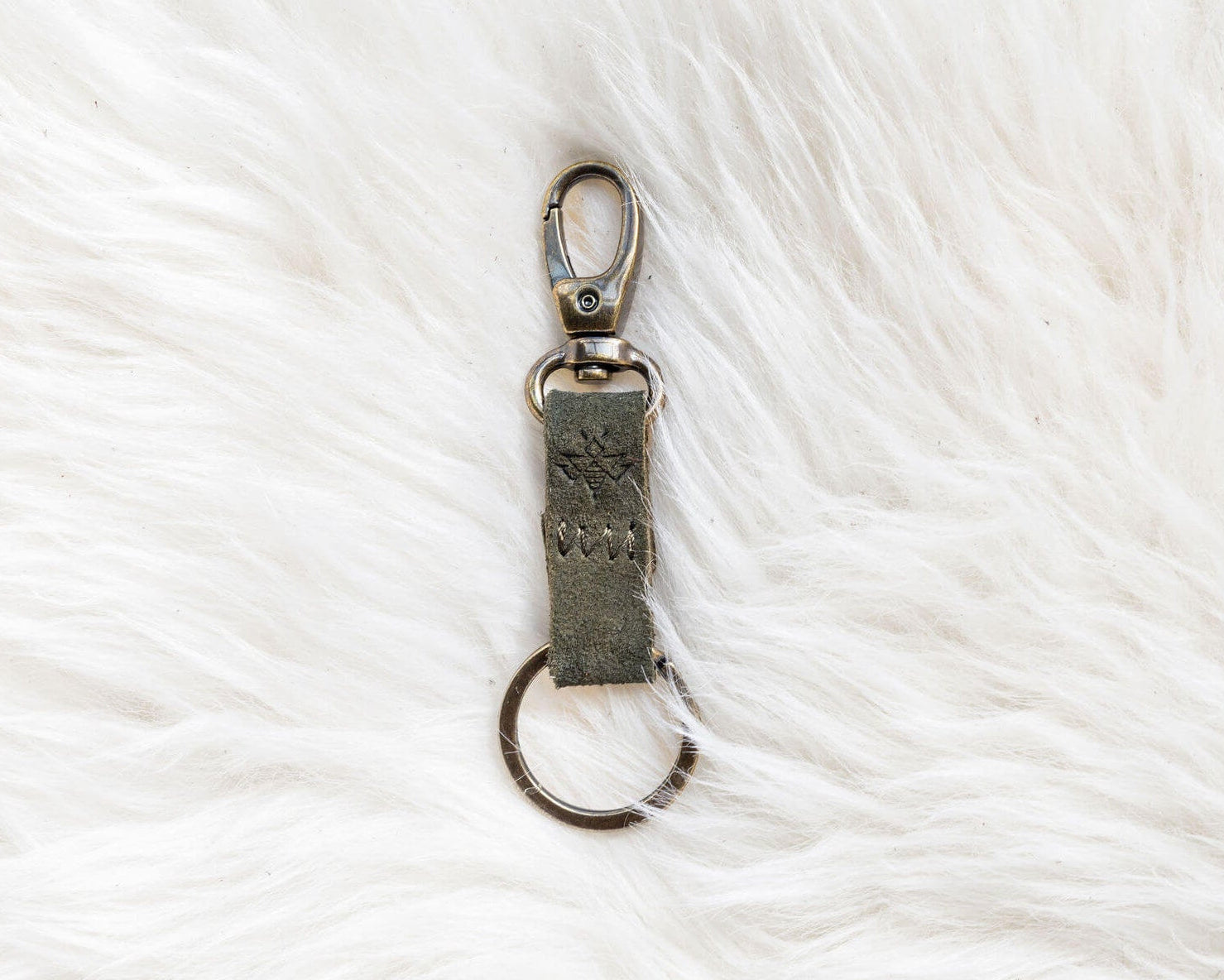 Keychain with a metal clasp on a white textured background