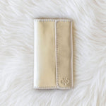 Beige wallet on a white fur surface