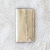 Beige wallet on a white fur surface