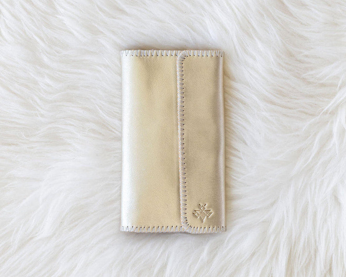 Beige wallet on a white fur surface