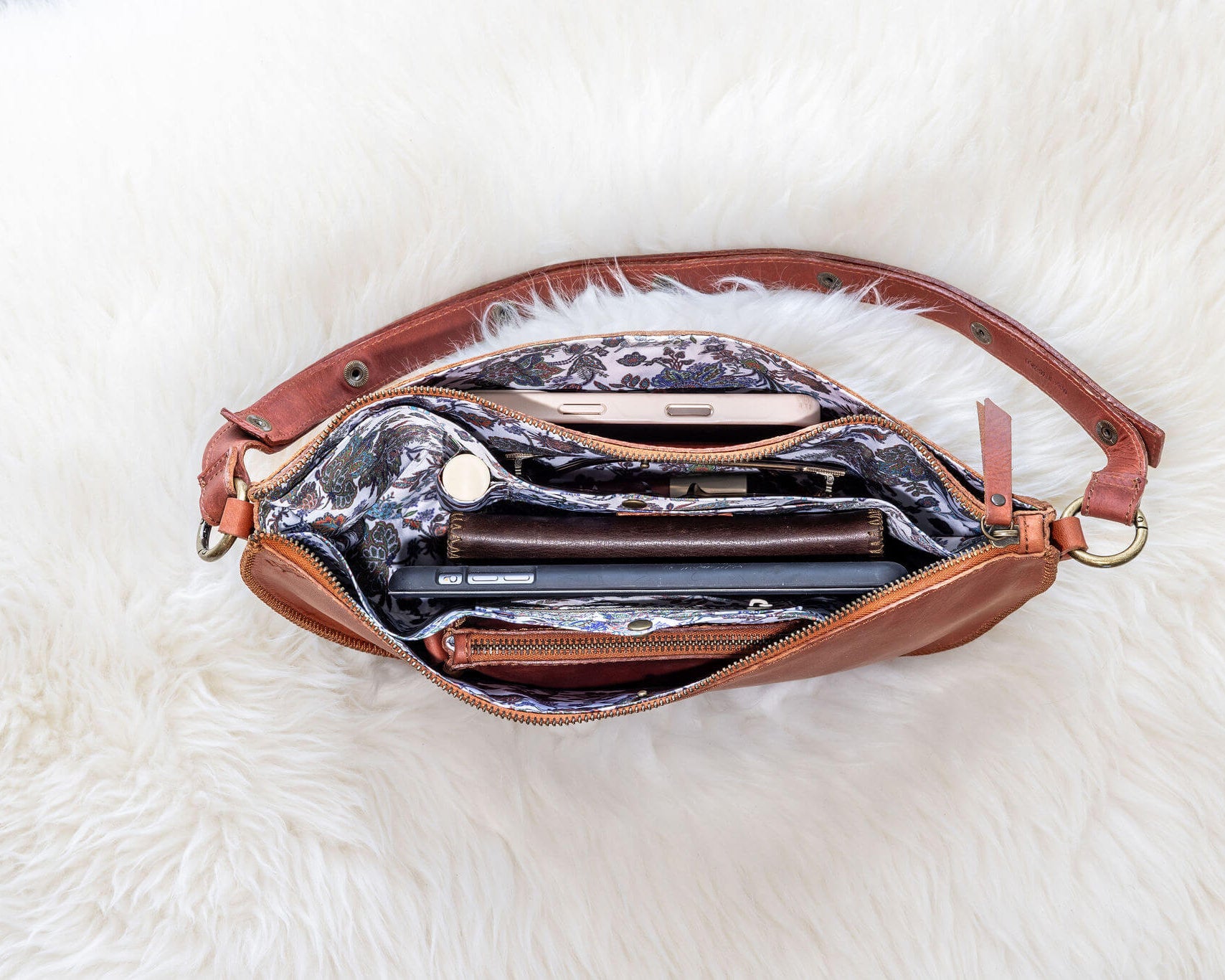 Brown leather handbag with a white fluffy surface underneath