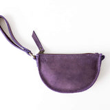 Purple leather pouch with a strap on a white background