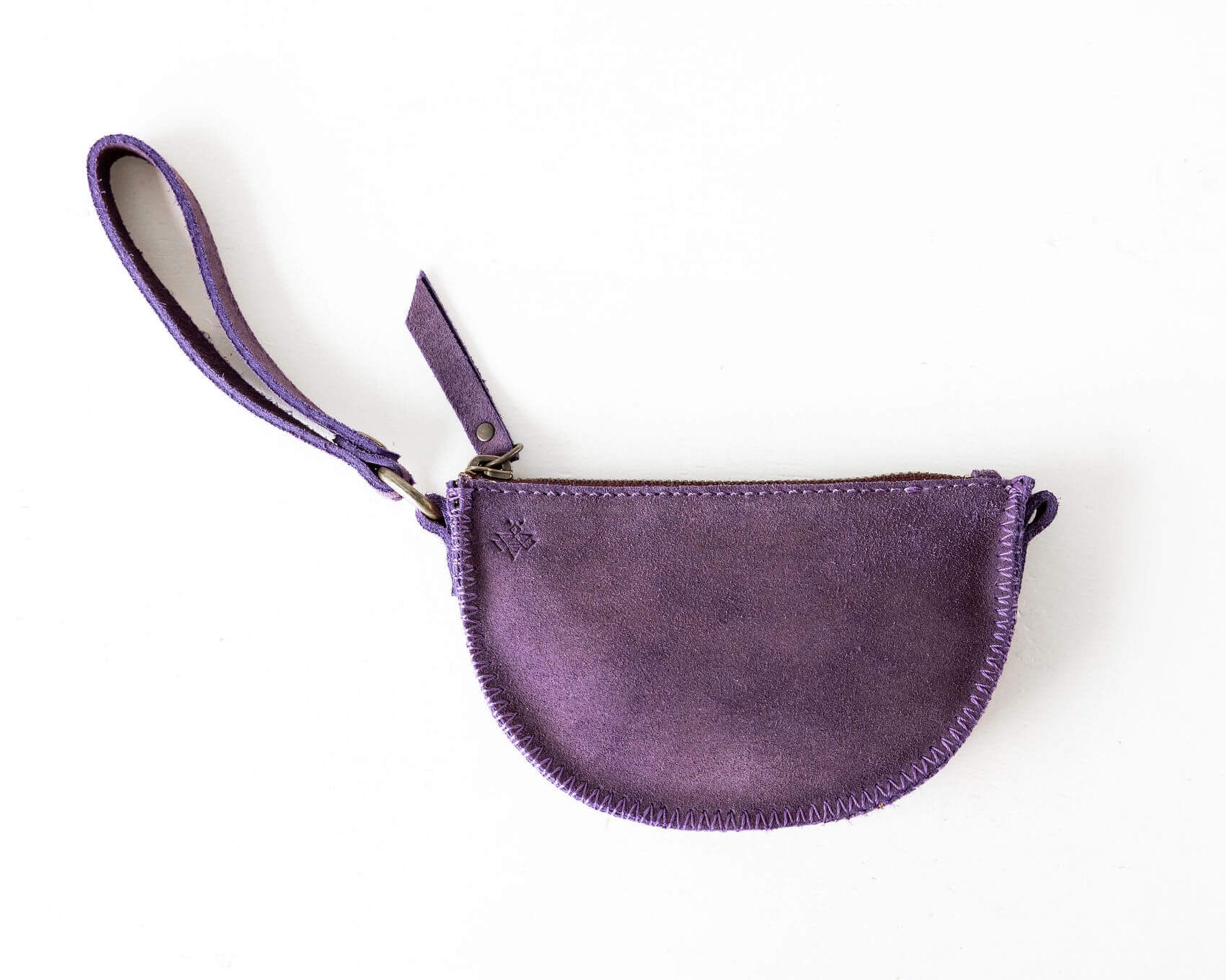 Purple leather pouch with a strap on a white background