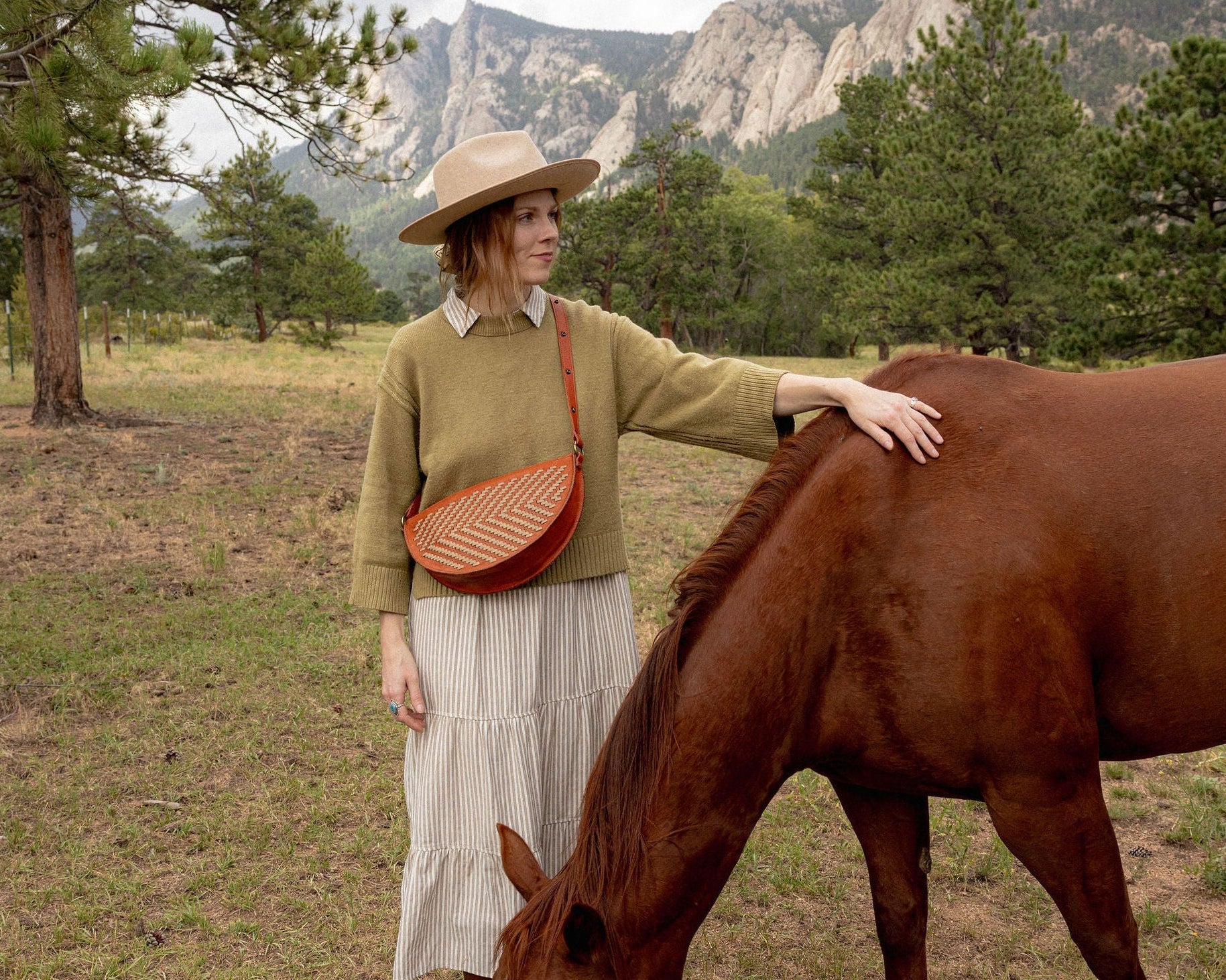 Woman wearing the Woven Terracotta & Seashell Queen Bee crossbody
