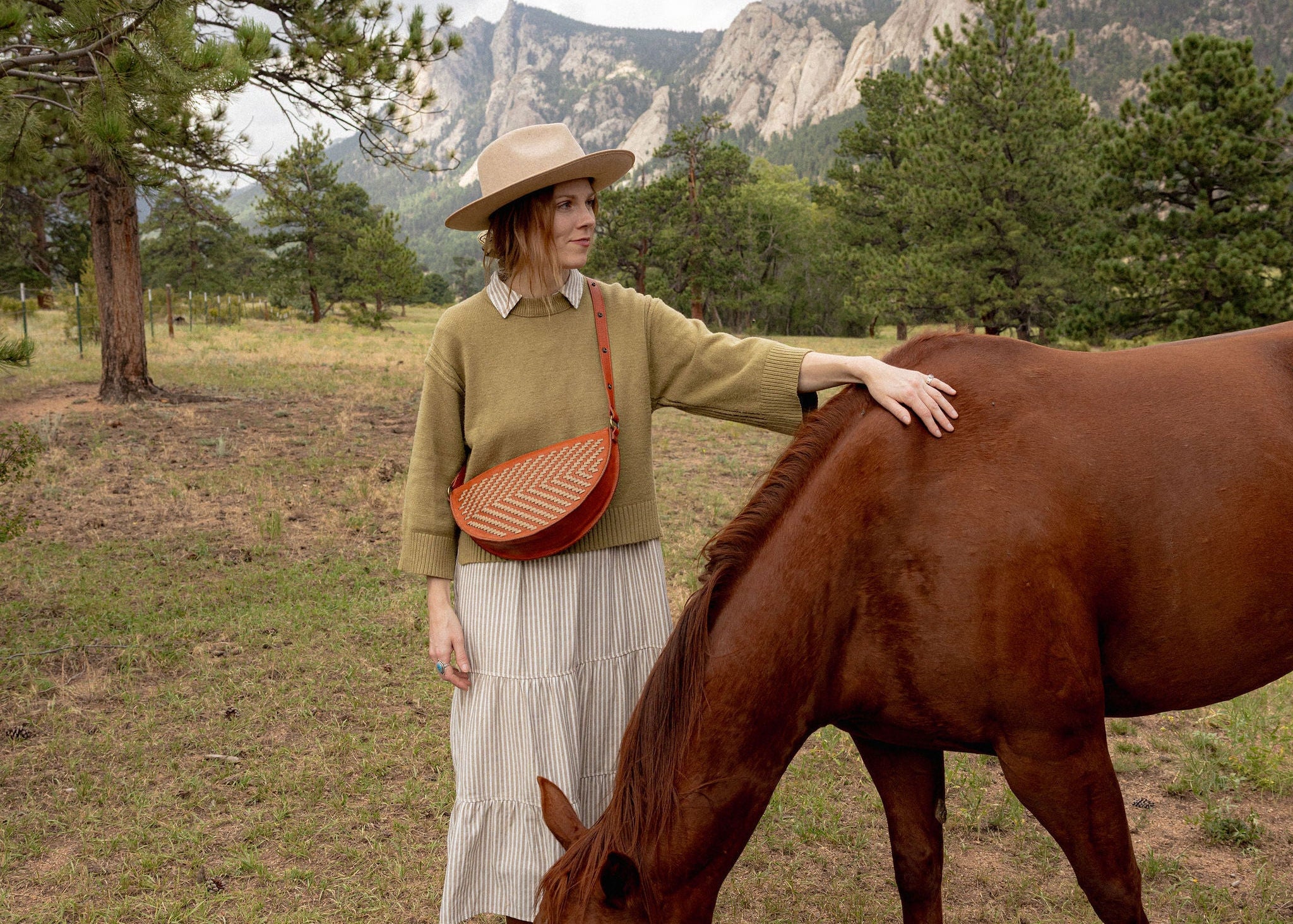 Woman wearing the Woven Terracotta & Seashell Queen Bee crossbody