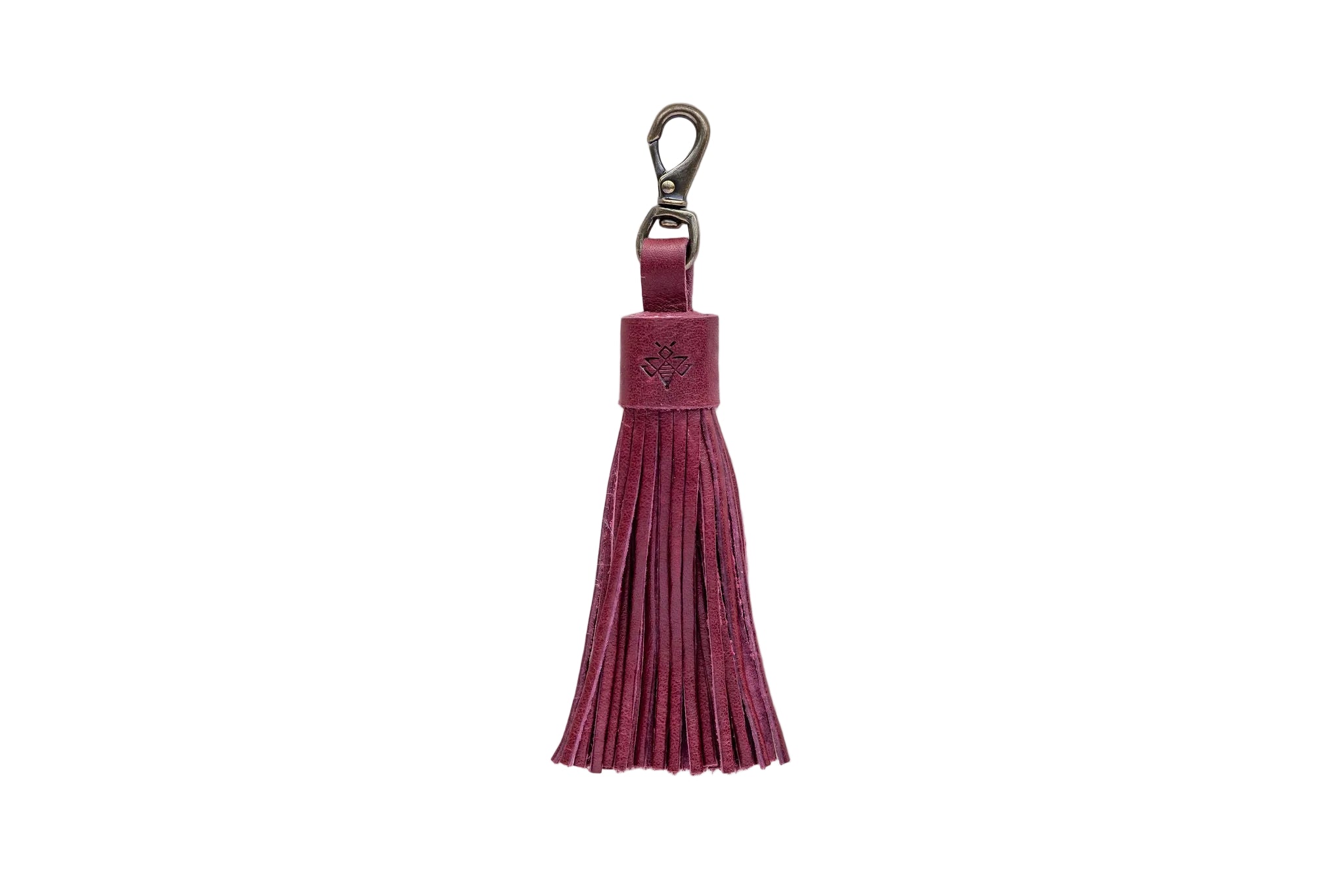 Maroon tassel keychain on a white textured background