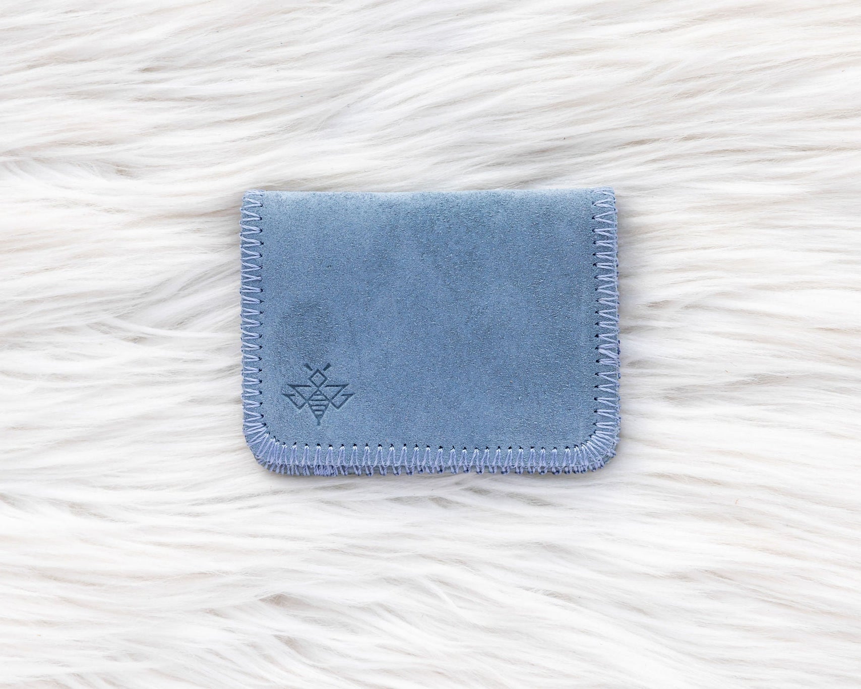 Blue fabric cardholder on a white textured background