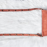 Mauve leather saddle pad on a white fur surface
