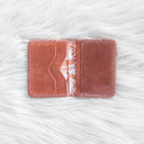 Rectangular pink fabric patch with a white floral pattern on a textured white surface