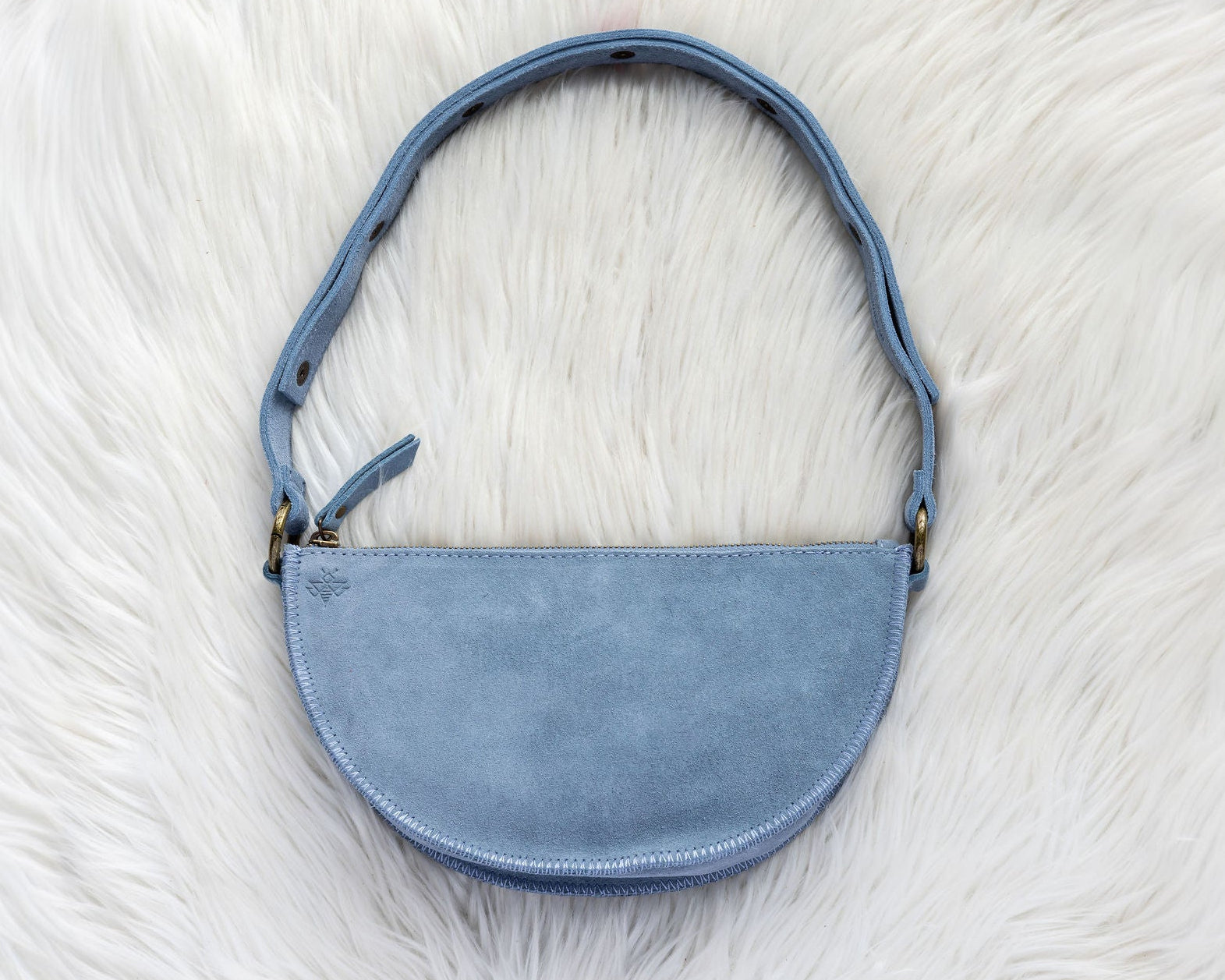 Blue handbag on a white fur surface