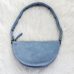 Blue handbag on a white fur surface