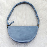 Blue handbag on a white fur surface